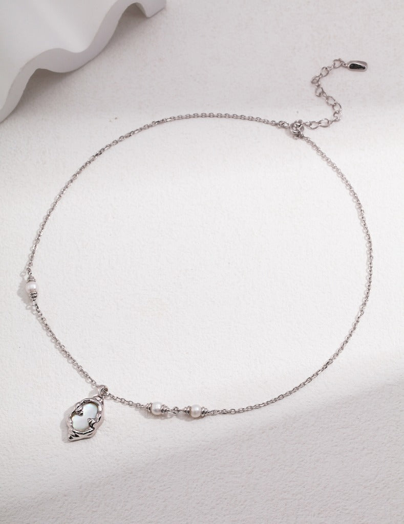 Elegant woman wearing silver pearl necklace with black dress for special occasion