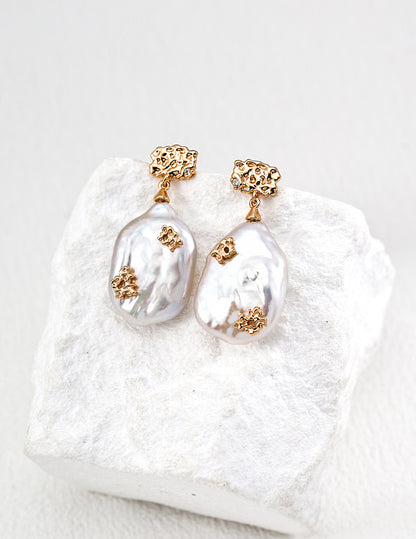 Close-up of S925 silver earrings with natural freshwater pearls and zirconia