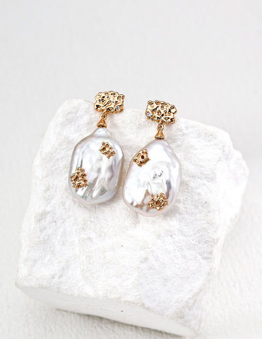 Close-up of S925 silver earrings with natural freshwater pearls and zirconia