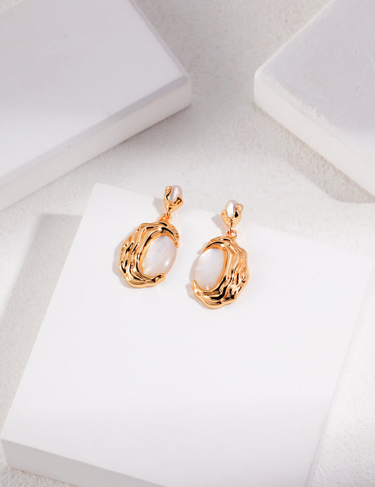 Gold drop earrings with irregular pearl cabochons and molten-style frames